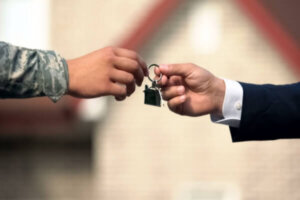 Military member getting keys to the house after receiving funding fee refund