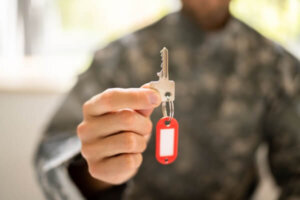 Soldier holding house keys.