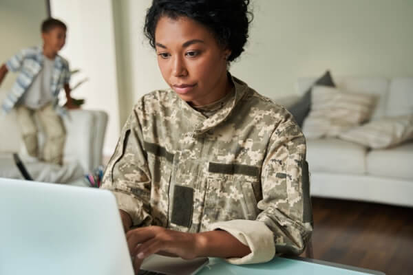 Woman in the military using computer to budget finances